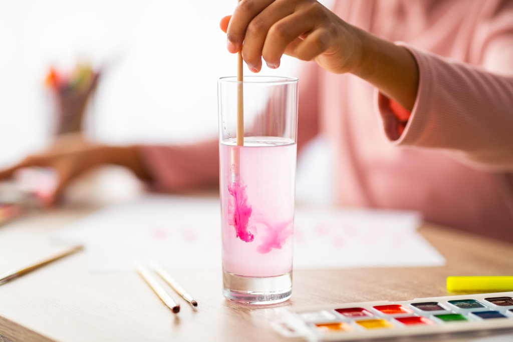 vecteezy_child-girl-washing-brush-with-pink-paint-in-glass-of-water_70383310
